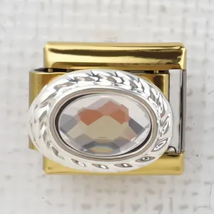 Close-up of gold and silver Italian charm with crystal and rope textured edge