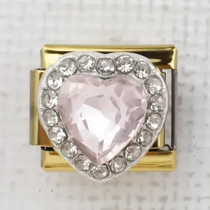 Macro detail of Italian charm link with pink heart crystal and sparkling rhinestones