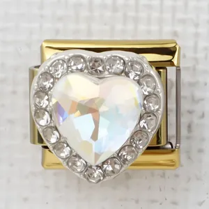 Macro detail of Italian charm bracelet link with gold heart and iridescent crystal stone