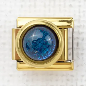 Detailed close-up of a gold Italian charm featuring a sparkling blue rabbit silhouette