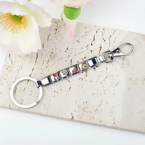Detail of stainless steel Italian modular charm keychain with colorful floral patterns