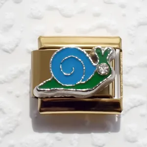 Detail of gold Italian charm link with colorful snail design and crystal accent