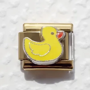Macro shot of gold stainless steel Italian charm featuring a cute yellow duck design
