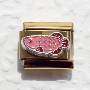 Close-up of a gold-plated stainless steel fish charm for modular Italian bracelets