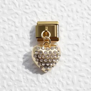 Macro shot of gold heart charm with clear crystals on Italian modular bracelet link