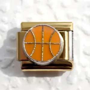Macro shot of gold Italian charm link with orange basketball design and silver accents