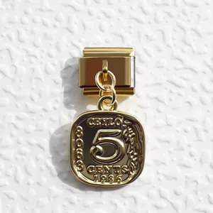 Macro view of a gold Italian link charm featuring a 1986 Ceylon 5 cents coin design