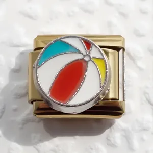 Detail of gold-plated stainless steel Italian charm link with colorful beach ball enamel inlay