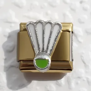 Macro shot of gold stainless steel Italian charm with badminton shuttlecock design