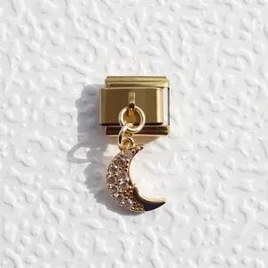 Macro view of gold Italian charm link featuring a crescent moon pendant with crystals