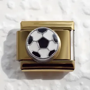 Close-up of golden Italian charm bracelet link with black and white soccer ball design
