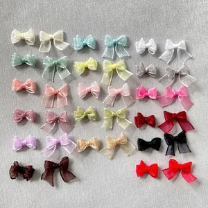 Detailed view of colorful organza ribbon bows for DIY nail art and handmade accessories