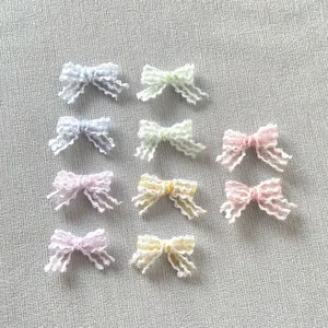 Close-up of colorful 2cm lace bows with scalloped edges for DIY hair accessories