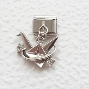 Macro view of silver origami crane charm with rhinestones for Italian link bracelets