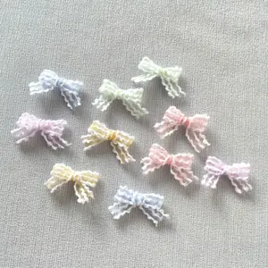 Close-up of 2cm mini lace mesh bows in macaron colors for DIY hair accessories and crafts