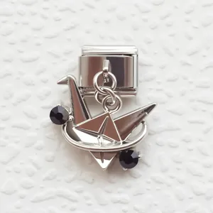 Italian charm link featuring a silver origami crane pendant with black crystal accents