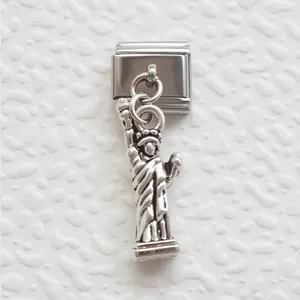 Macro view of stainless steel Italian charm link featuring a detailed Statue of Liberty
