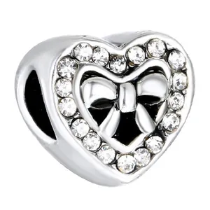 Silver heart bead with bow tie design and white zircon inlay for charm bracelets
