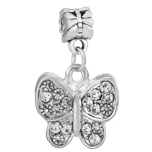 Detailed macro view of butterfly charm with silver plating and shimmering crystals