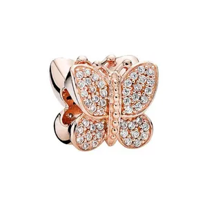 Macro shot of rose gold butterfly charm bead with micro-paved sparkling cubic zirconia crystals
