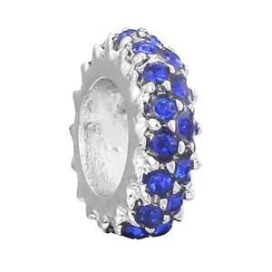 Detailed view of silver gear-edged charm bead with double-row navy blue zircon stones