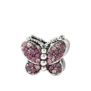 Macro detail of silver butterfly charm bead with pink and purple pavé crystals