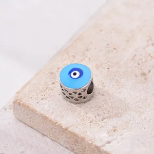 Macro shot of blue enamel evil eye charm with hollow silver metal dots for DIY bracelets