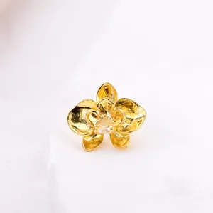 Elegant gold orchid charm with textured petals and a clear zircon stone on stone base