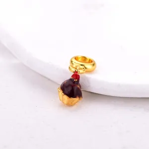Detailed close-up of cherry chocolate cupcake charm with gold finish for DIY jewelry