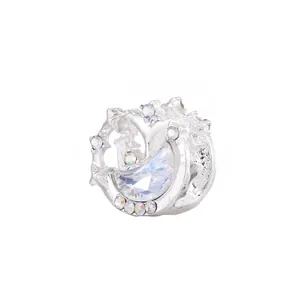 Detailed view of silver moon charm with vibrant colorful crystals and moonstone inlay