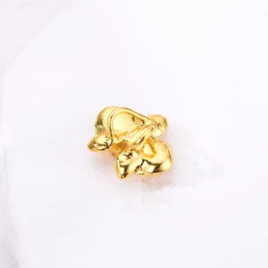 Macro shot of 3D golden orchid charm with polished finish and intricate petal details