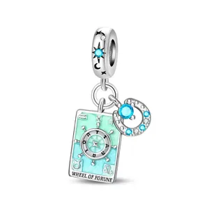 Silver Tarot Wheel of Fortune charm with crescent moon and sparkling blue zircons