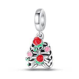 Gothic style alloy ribcage charm with red rose and pink floral enamel details