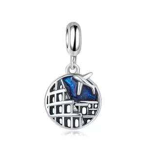 Silver travel charm with blue enamel night sky, airplane and Colosseum silhouette