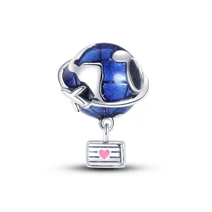 Detailed view of ocean blue earth charm with silver airplane and pink heart tag pendant