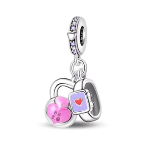 Detail of silver charm with pink enamel heart and purple smart watch bead design