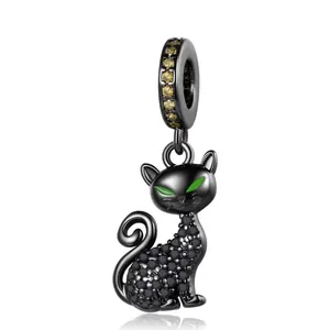 Exquisite black cat charm in dark finish with green eyes and yellow gemstone bail