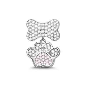 Macro detail of bone and paw print pendant with pink and white zircon stones