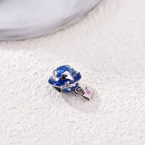 Globe and airplane travel charm with blue enamel finish and silver heart pendant