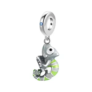 Chameleon pendant charm with green enamel and blue gemstone inlay on a silver ring