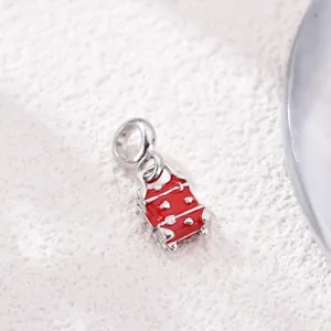 Macro view of red enamel suitcase charm with silver accents for DIY charm bracelets
