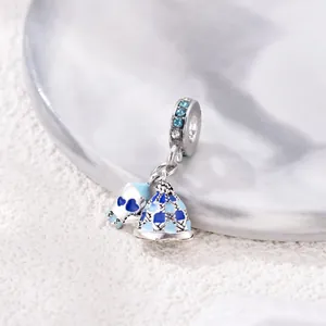 Detailed macro of silver blue skull and knitted hat charm with blue zircon inlay