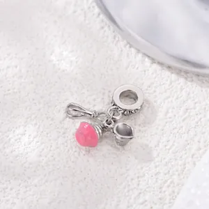 Detailed macro view of pink cupcake and whisk charm pendant for DIY bracelet beads
