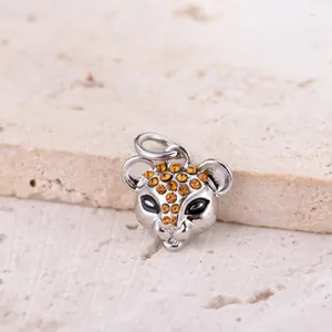 Macro shot of silver alloy leopard head charm with sparkling orange rhinestones