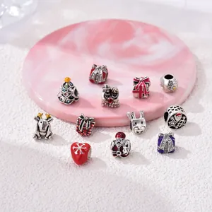 Christmas charm set with tree, reindeer, and gift box designs on marble tray