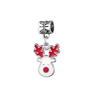 Christmas reindeer charm with red antlers and white enamel details in polished silver finish
