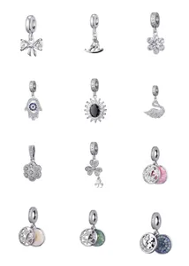 Detailed macro display of diverse silver-tone charms with cubic zirconia and enamel inlay
