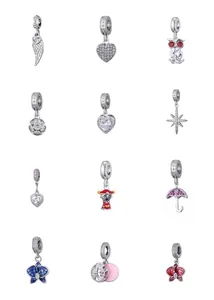 Macro shot of twelve mixed zircon bead charms with colorful enamel and crystal details