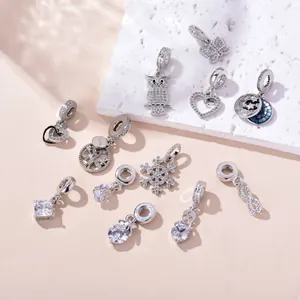 Macro detail of copper zircon charms featuring heart and snowflake designs for DIY jewelry