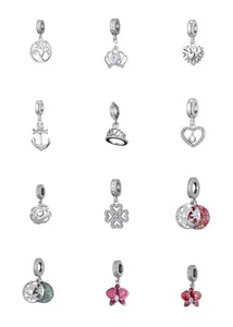 Detailed collection of assorted copper charms with cubic zirconia and enamel patterns